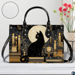 Straight-on studio view of black cat candles art highlighting detailed golden surface texture.