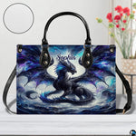 Front view of cosmic dragon handbag on white tabletop with circular textured exterior swatch.