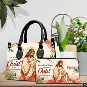 Good Shepherd handbag and wallet displayed on wooden table beside potted plant.