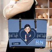 Model carrying Denim Blue Clinician Tote Handbag over shoulder in a modern indoor room.