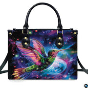 Studio front shot of cosmic hummingbird handbag against white studio background.