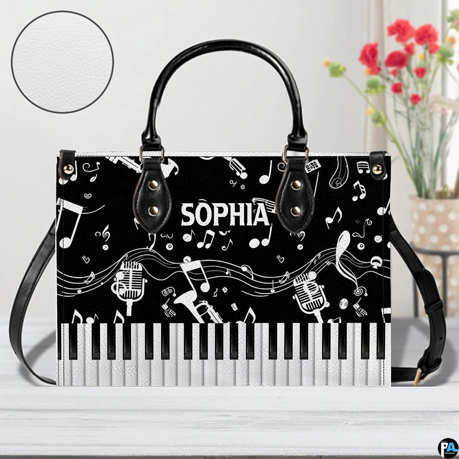 Tabletop presentation of musical artwork positioned beside floral vase and circular detail inset.