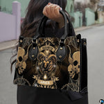 Woman carrying Gothic Ram Zodiac Handbag outdoors by top handle on a city sidewalk.