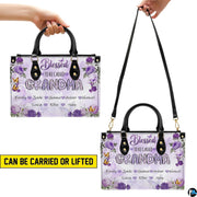 Perspective angle view of floral handbag highlighting side depth and continuous rose pattern alignment.