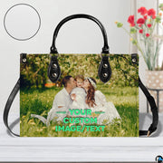 Front view of handbag standing upright on white surface with circular texture inset.