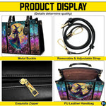 Stained glass witch handbag and wallet on wooden table beside houseplant and wire trellis.