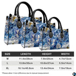 Side perspective view of blue and white butterfly handbag and wallet pair