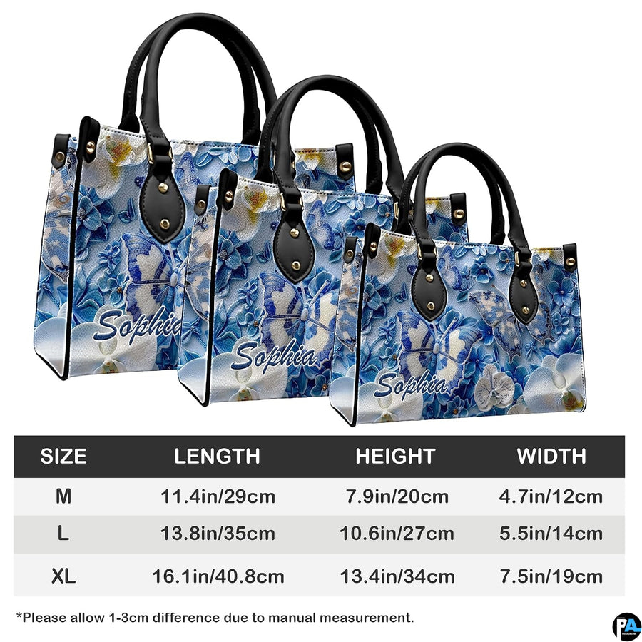 Side perspective view of blue and white butterfly handbag and wallet pair
