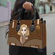 Chibi nursing assistant handbag held outdoors showing scale against neutral street setting.