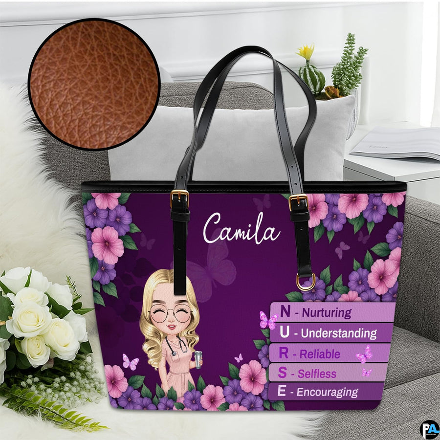 Studio display of Purple Floral Clinician Handbag resting on a sofa with inset detailing surface grain.