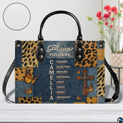 Home lifestyle view of Christian cross butterfly handbag on white table beside decorative flowers