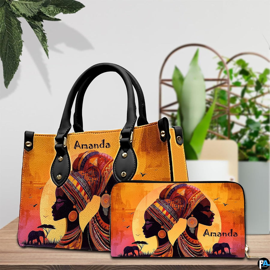 African sunset artwork arrangement displayed on a polished tabletop beside vibrant green foliage.