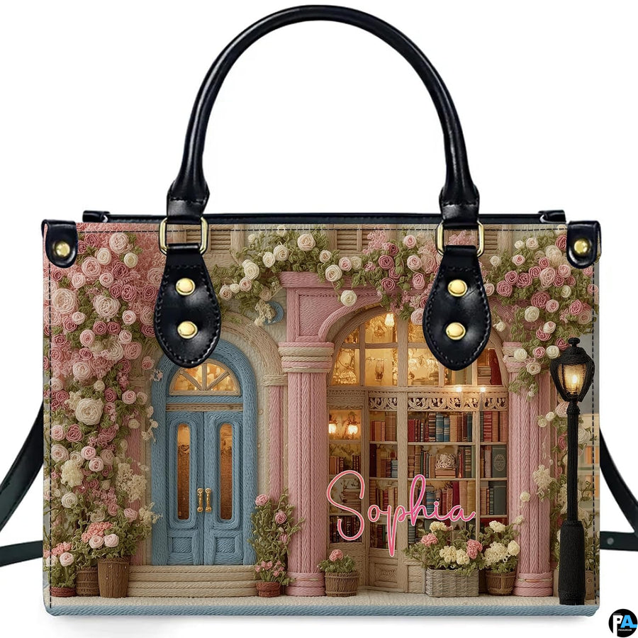 Front product view of embroidered rose bookshop handbag on white background.