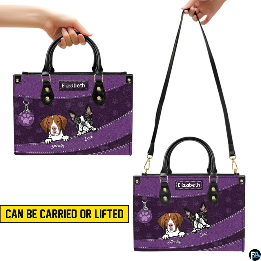 Front view of matching purple wallet showing coordinating cartoon dogs and paw print background.