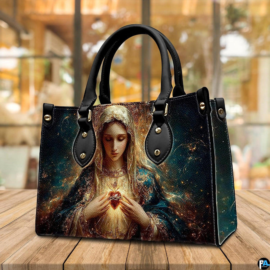 Handbag and matching wallet featuring Blessed Virgin Mary artwork on cafe tabletop.