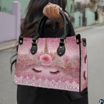 Side profile of pastel unicorn handbag showing structured silhouette and black carrying handles.