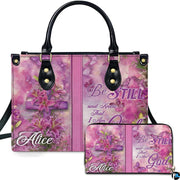 Pink lily cross handbag and matching zip wallet shown against studio background with floral artwork.