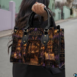 Angled view showing the witchy emporium facade and glowing lantern details printed on the handbag.