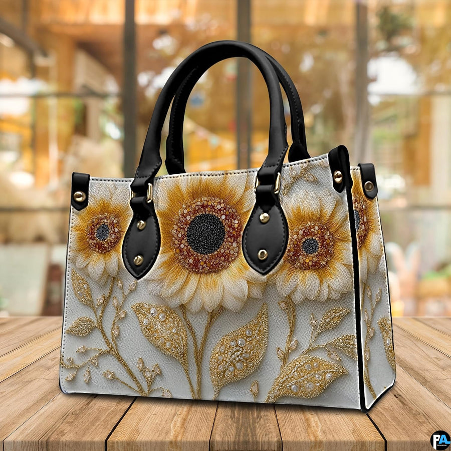 Back view of sunflower handbag displaying continuous off-white background with golden vine detailing.