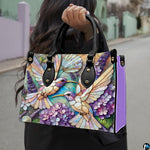 Side profile view of mosaic botanical handbag displaying structured silhouette and depth.
