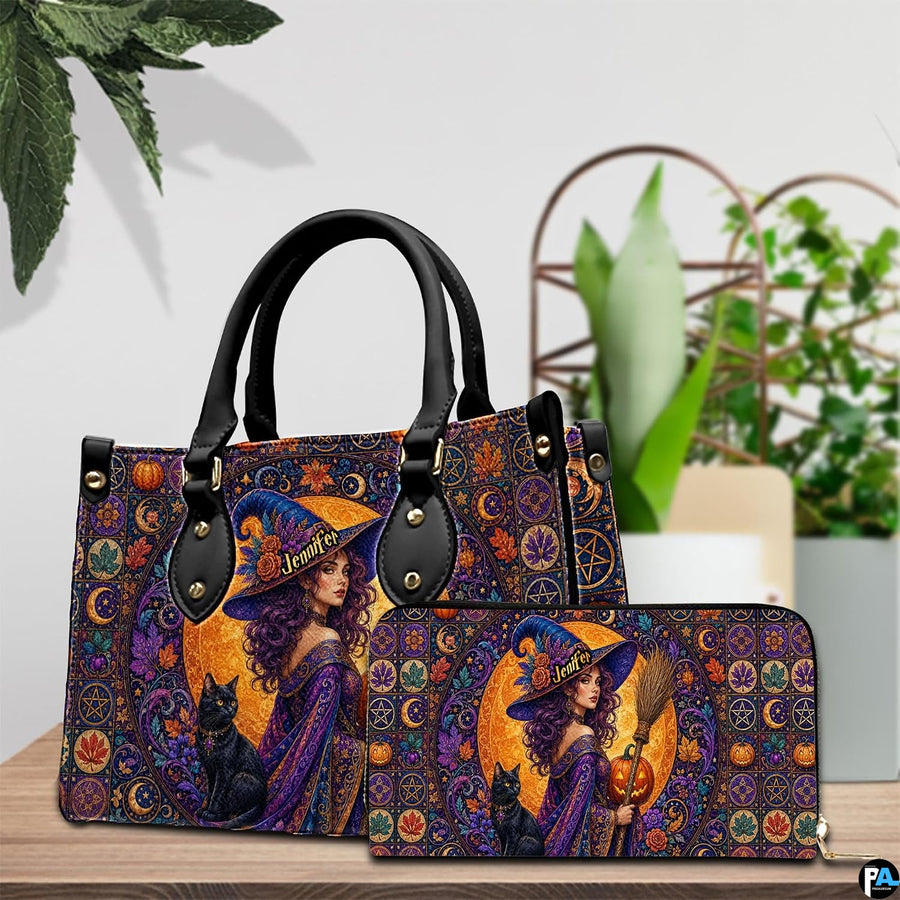Pair showcase featuring gothic witch artwork placed on wooden tabletop beside potted plant.