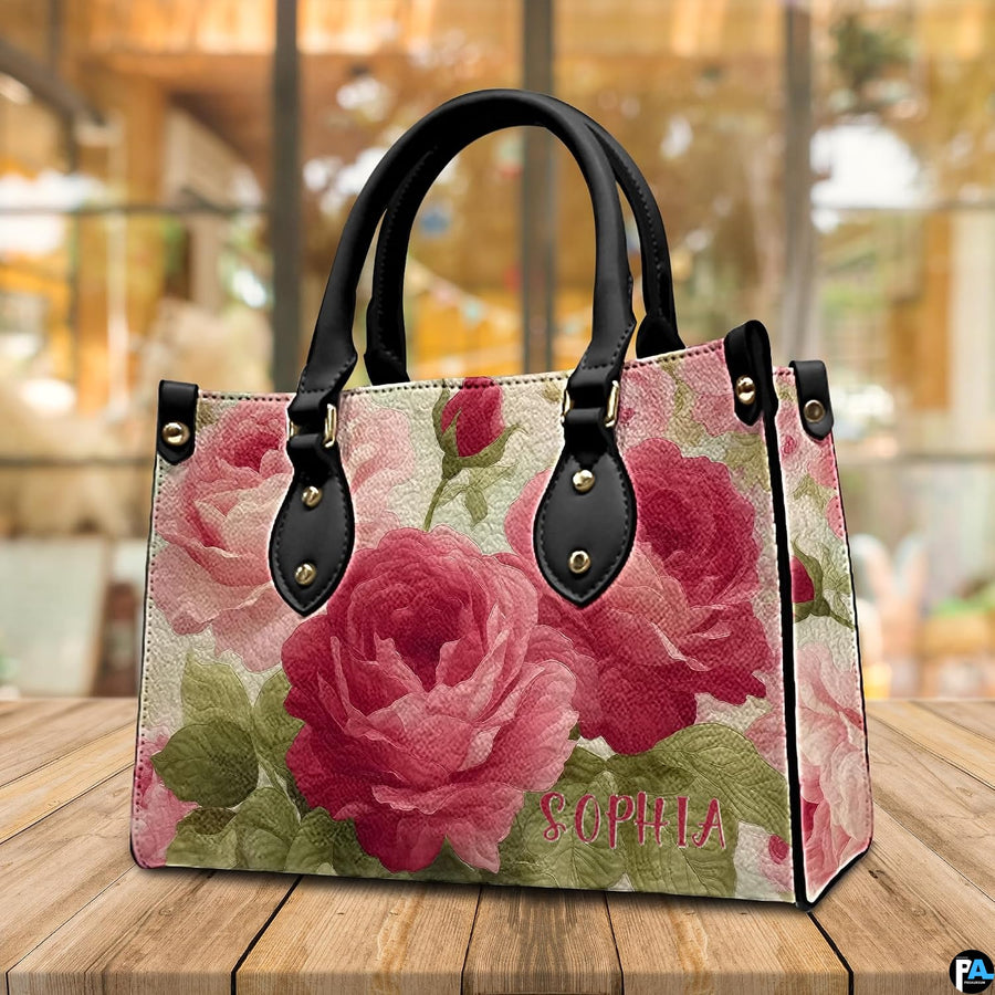 Tabletop presentation of vintage rose art accessory resting on smooth wooden surface.