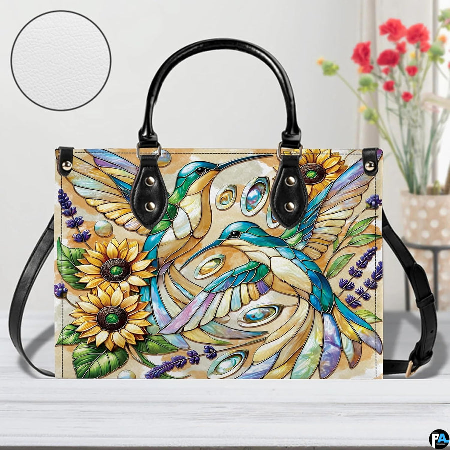 Back view of mosaic hummingbird handbag showing continuous floral pattern on white background.