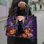 Outdoor street view showing winged black cat and pumpkin artwork held by pedestrian along city sidewalk.