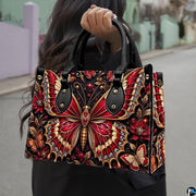 Lifestyle presentation of crimson butterfly handbag and wallet set with accessories
