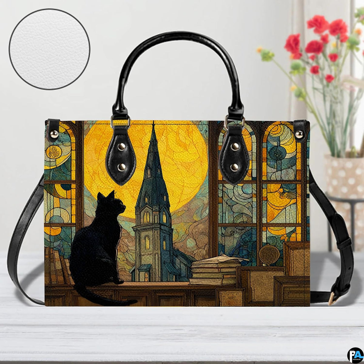 Close studio perspective of stained glass cat painting positioned on white surface beside flowers.