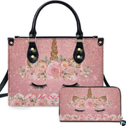 Front view of floral sleeping unicorn handbag and matching wallet set on sparkling pink background.
