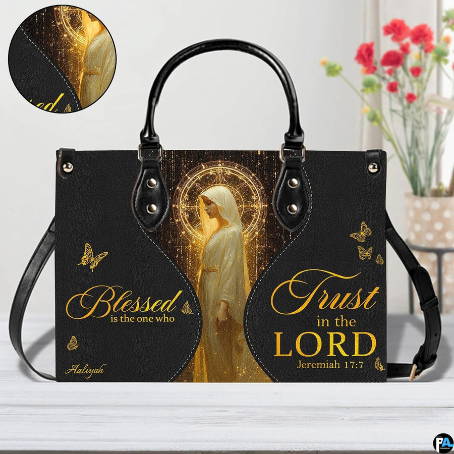 Front view of matching wallet displaying golden sacred figure, celestial halo, and butterfly accents.