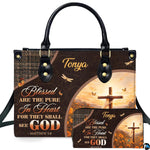 Front view of rustic wooden cross handbag and matching wallet with sunrise flower field and houndstooth trim.