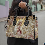 Matching zip wallet displaying relief carved praying madonna with baroque gold aureole and sculpted ivory blossoms.