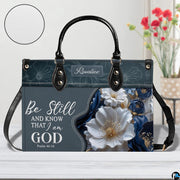 Side perspective view of Bible verse purse highlighting structured silhouette and carry handles.