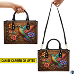 Handbag displayed in two carrying styles held by top handle and shoulder strap on white background.