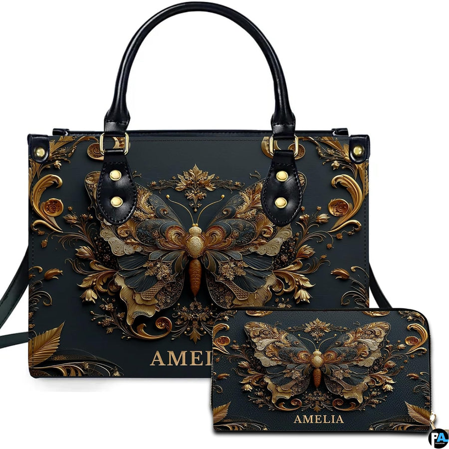 Front view of antique gold Baroque butterfly handbag and matching zip wallet on white backdrop