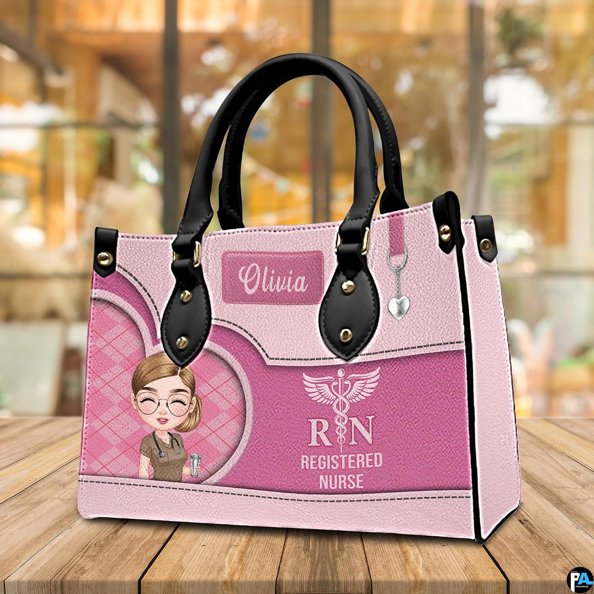 Front view of pink chibi nurse handbag standing upright on wooden tabletop with cafe lighting.