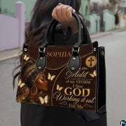 Close view of leopard headwrap portrait handbag artwork in dark brown, black, cream, and gold
