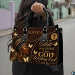 Close view of leopard headwrap portrait handbag artwork in dark brown, black, cream, and gold