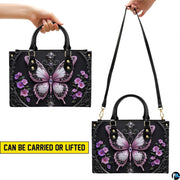 Top view of gothic butterfly handbag showing zippered top closure and dual structured handles