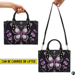 Top view of gothic butterfly handbag showing zippered top closure and dual structured handles