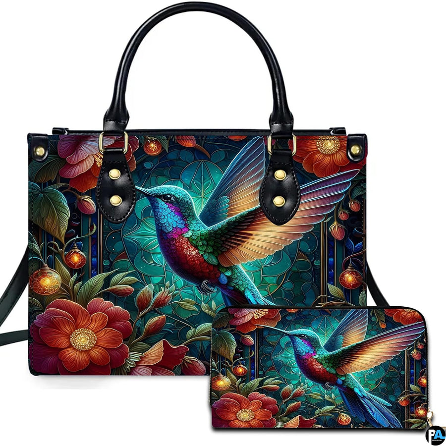 Front view of luminous hummingbird handbag and matching wallet with glowing lanterns and crimson flowers.