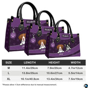 Coordinated set view of purple illustrated puppy handbag and matching wallet on white background.