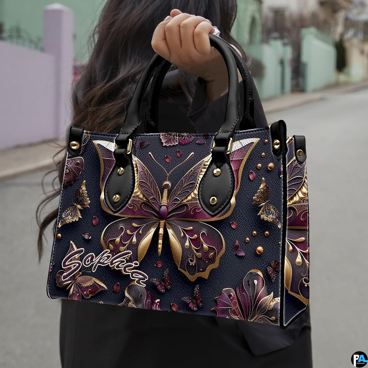 Perspective view of sculptural gold butterfly handbag and wallet pair