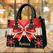 Coordinating holiday wallet featuring red ribbon bow and golden snowflake pattern on black background.