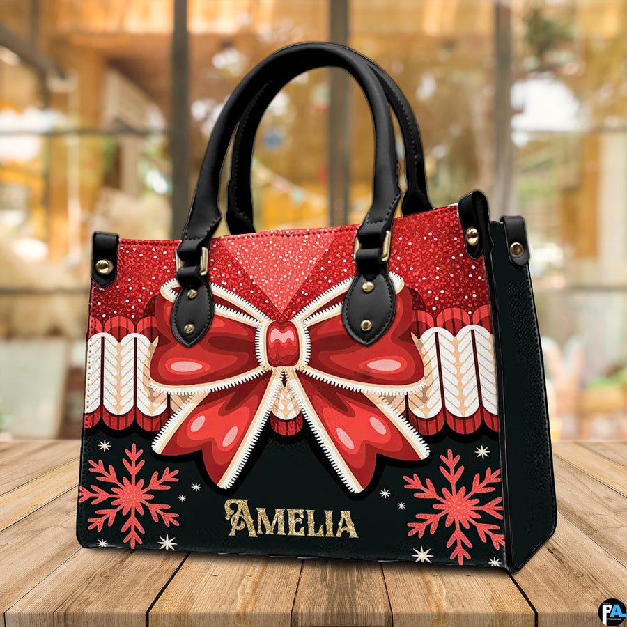 Coordinating holiday wallet featuring red ribbon bow and golden snowflake pattern on black background.