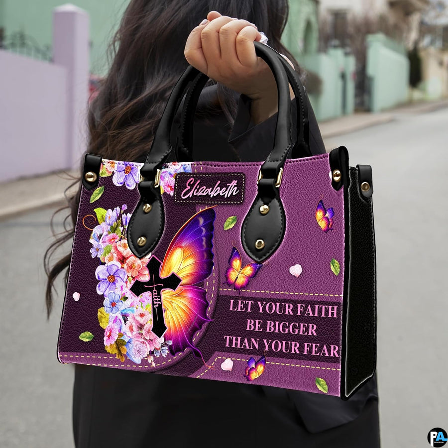 Model carrying the purple butterfly cross handbag with black top handles in an outdoor setting