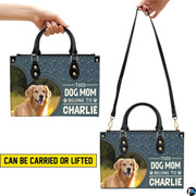 Front view of matching wallet showing golden retriever portrait and paw print patterned background.