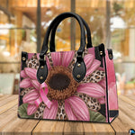 Angled tabletop perspective featuring pink sunflower art accessory showcased in indoor cafe setting.